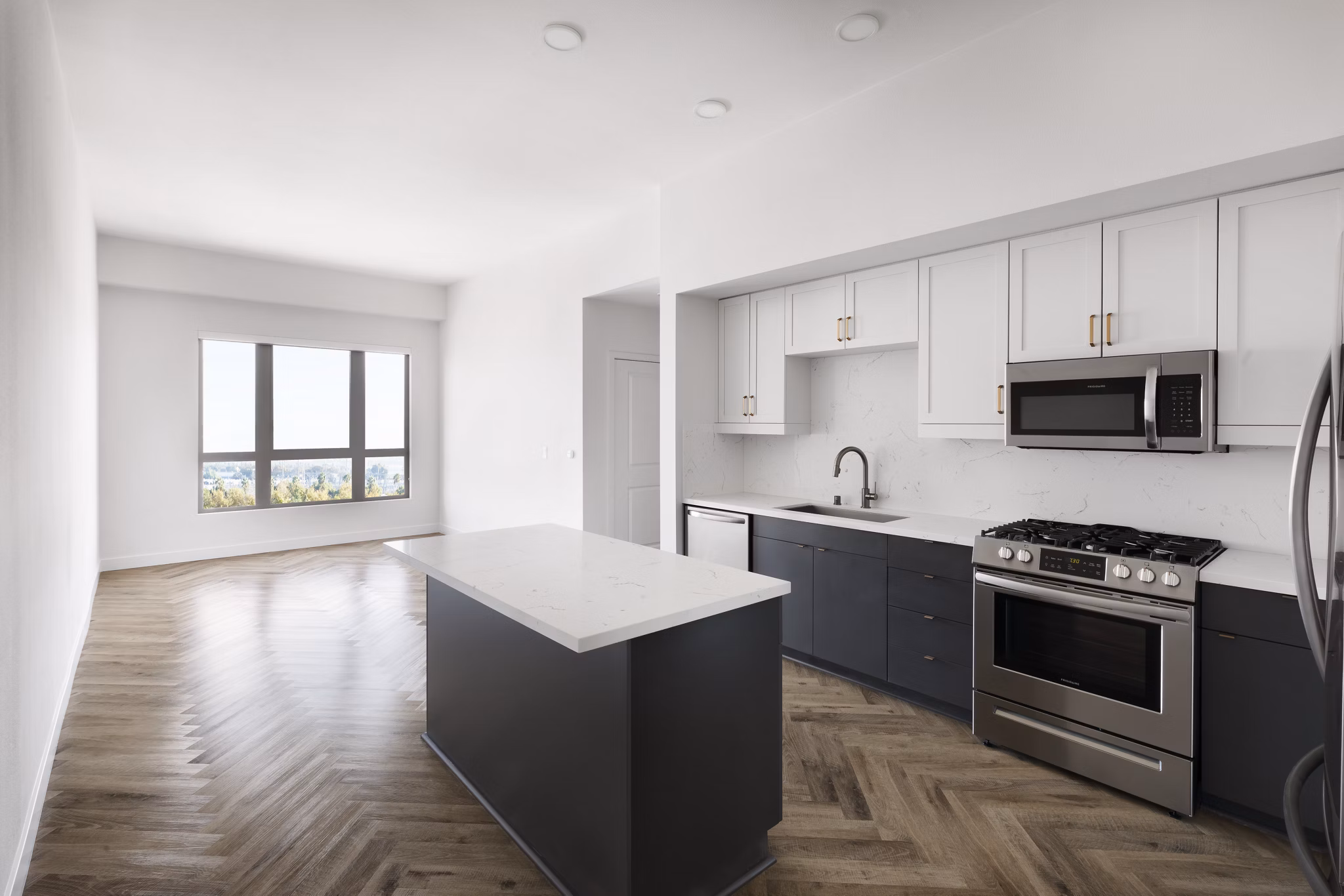 Modern kitchen with stainless steel appliances and granite countertops at Mode Apartments, luxury living