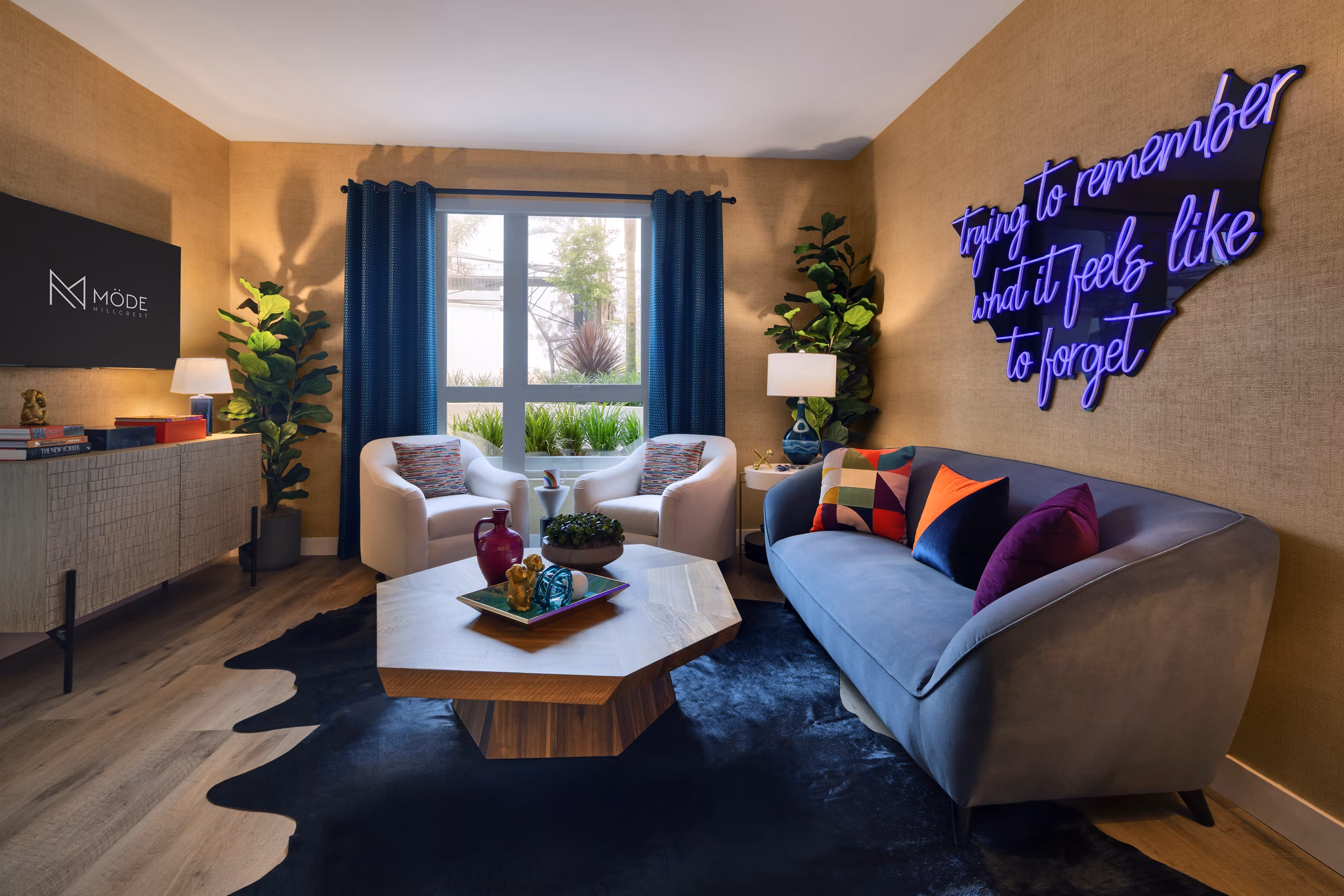 Modern living room with sleek furniture and large windows in Mode Apartments