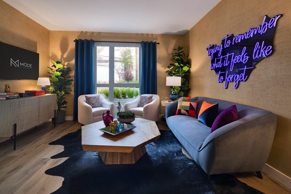 Modern living room with sleek furniture and large windows in Mode Apartments