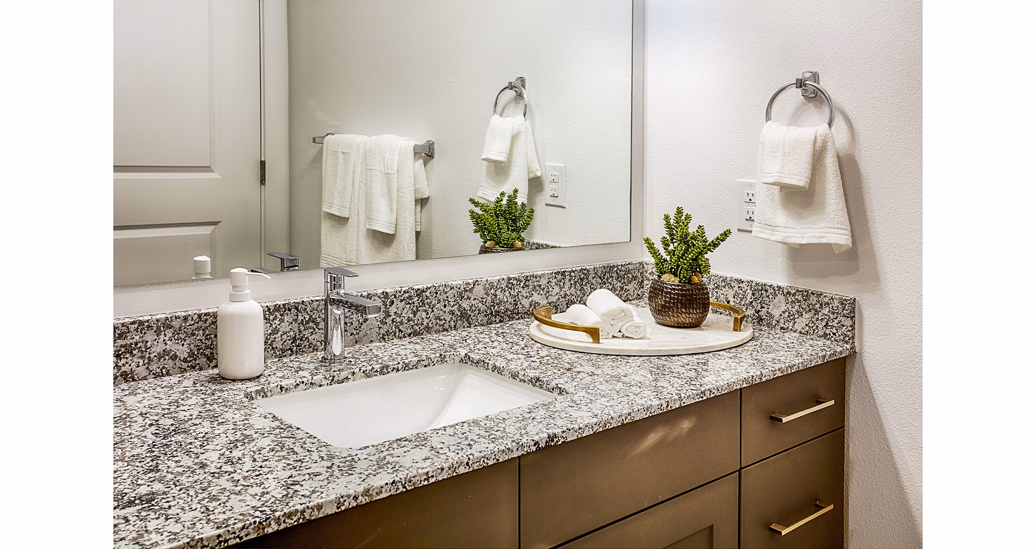Bathroom featuring modern fixtures and dual sinks at Ascend at Prairie Village Apartments