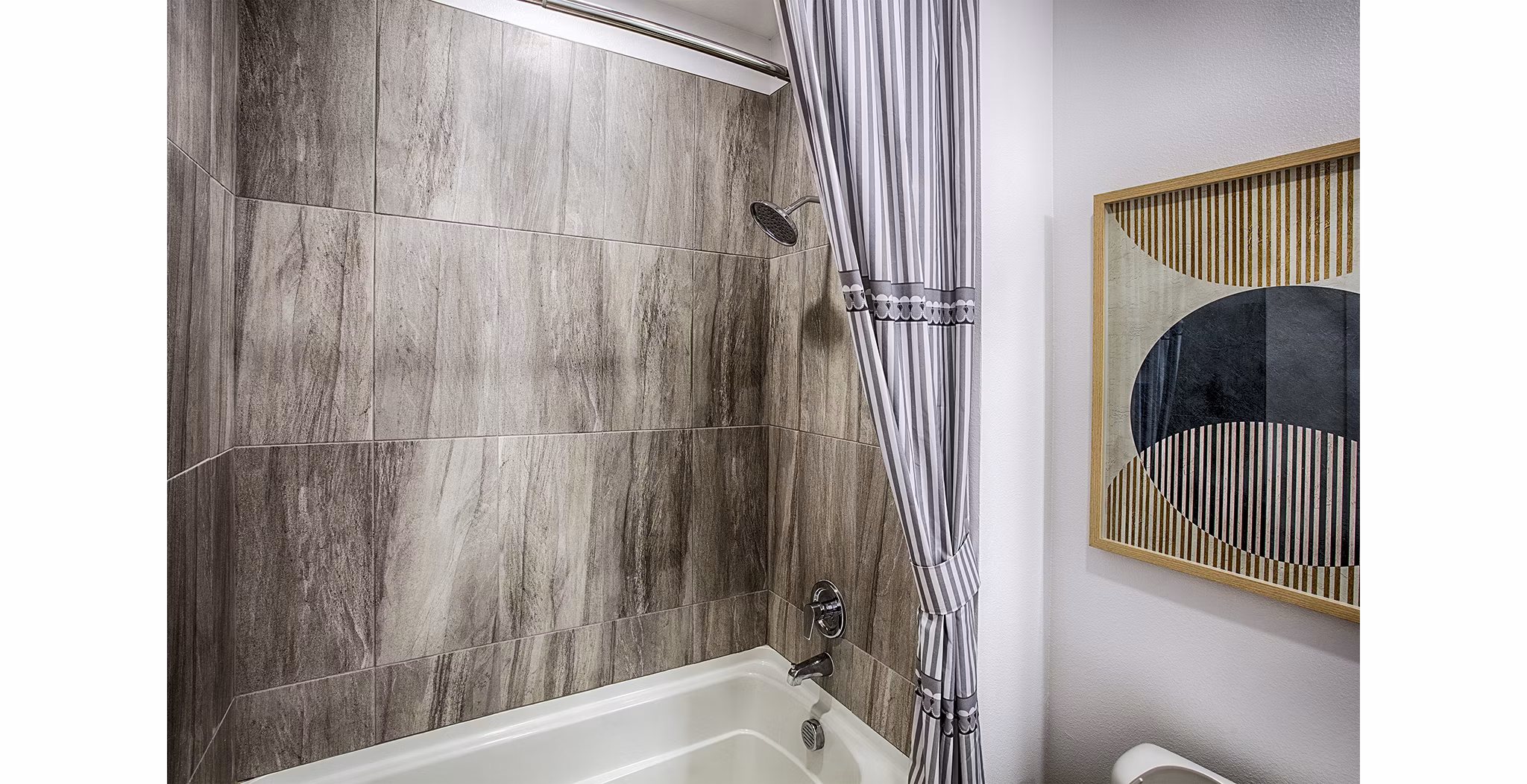 Bathroom featuring modern fixtures and granite countertops in Ascend at Prairie Village Apartments