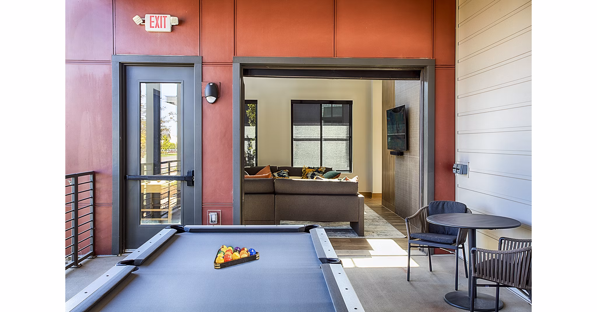 Modern game room featuring pool table and lounge seating at Ascend at Prairie Village Apartments
