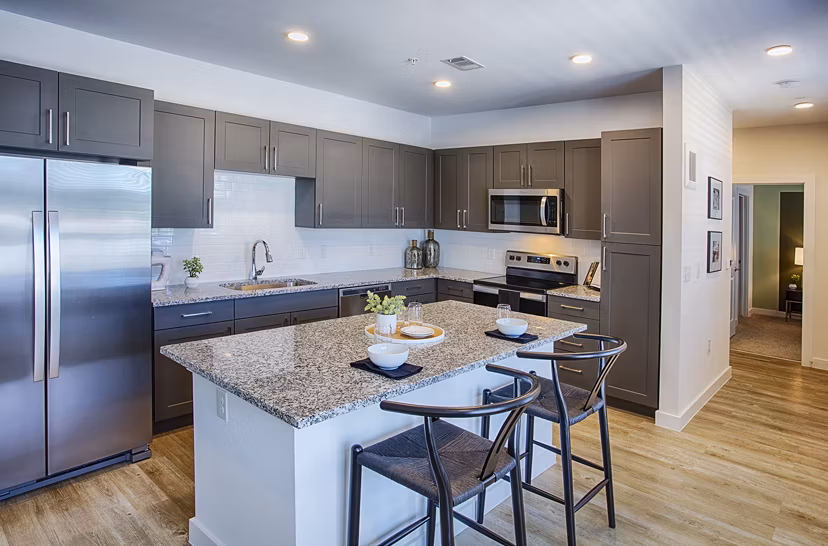 Modern kitchen with stainless steel appliances at Ascend at Prairie Village Apartments