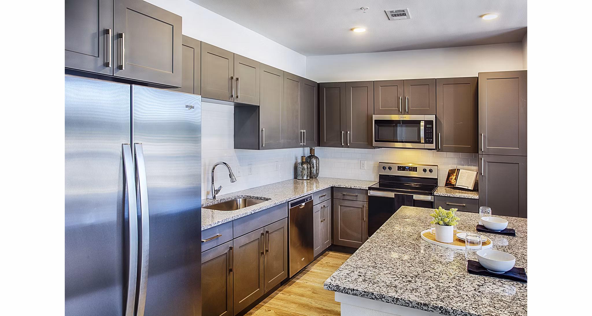 Modern kitchen with stainless steel appliances at Ascend at Prairie Village Apartments