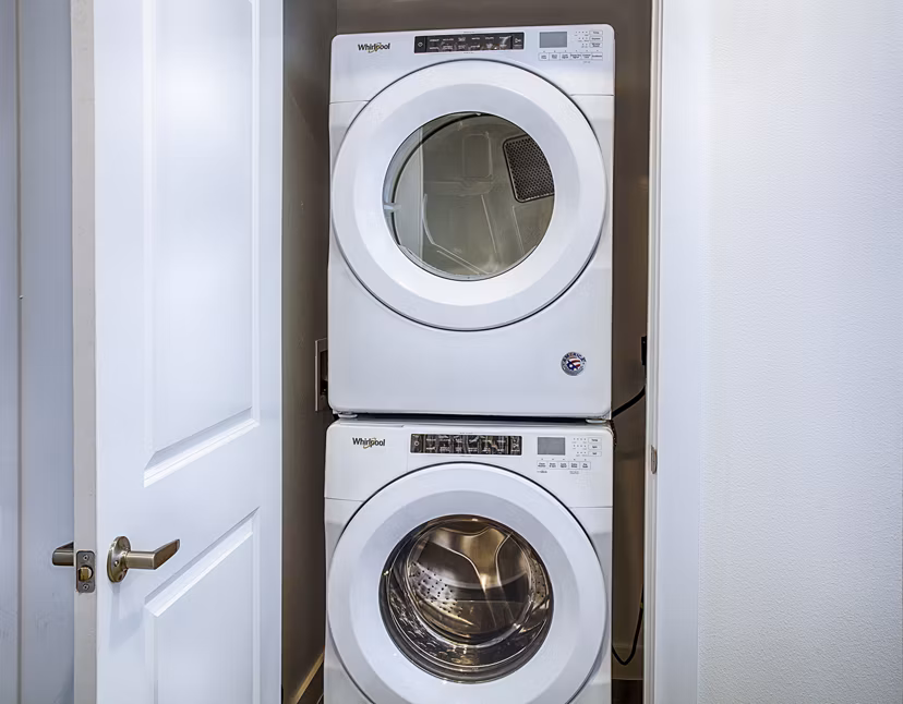 Laundry room with modern washers and dryers at Ascend at Prairie Village Apartments