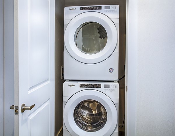 Laundry room with modern washers and dryers at Ascend at Prairie Village Apartments