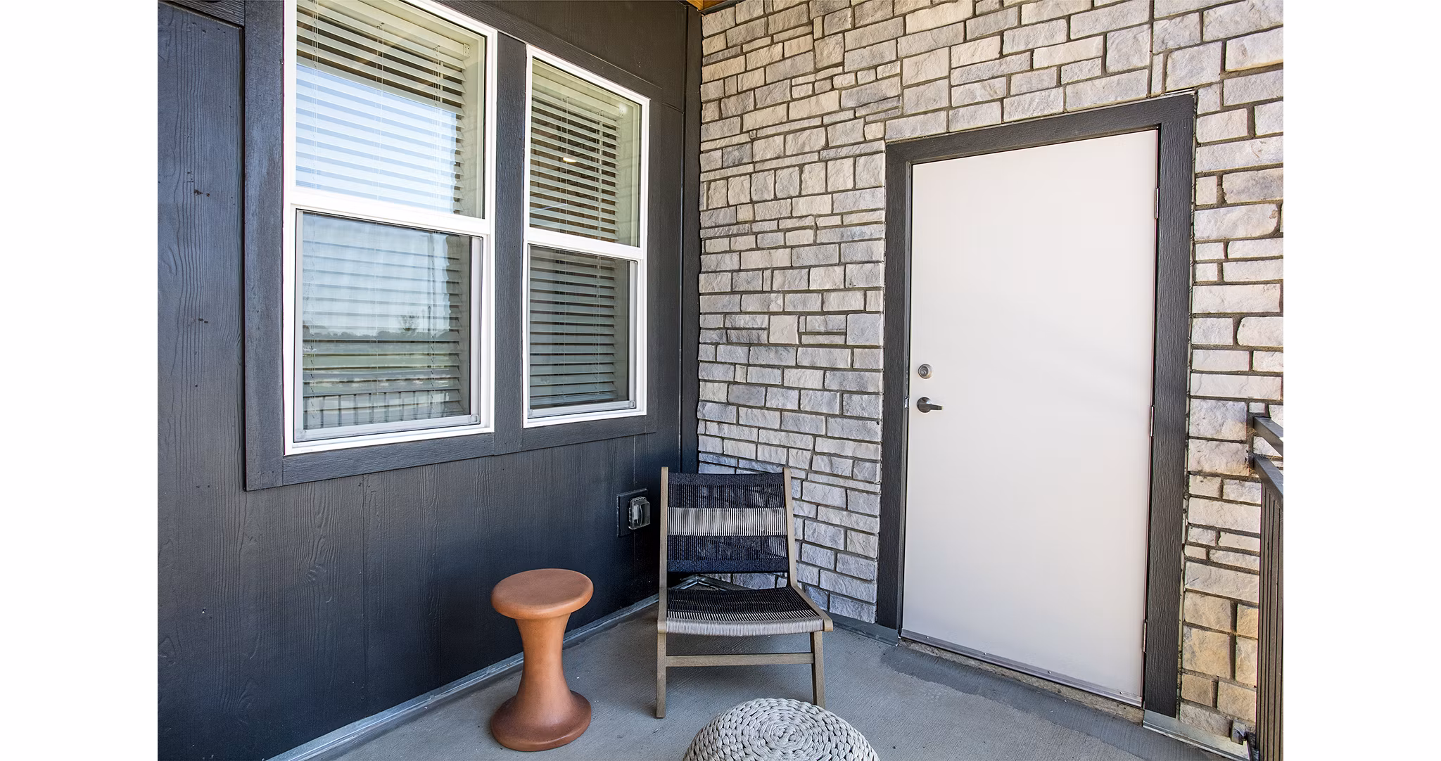 Ascend at Prairie Village: Modern patio space with comfortable seating and lush greenery at luxury apartments in a tranquil setting