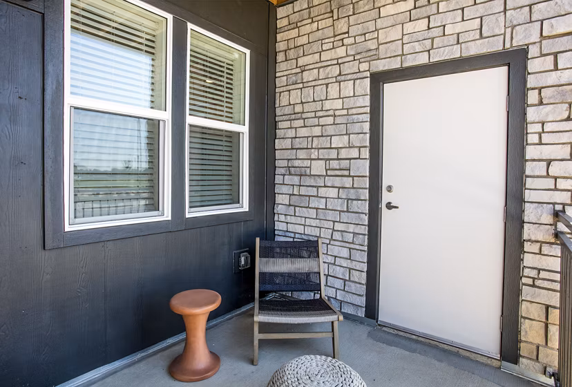 Ascend at Prairie Village: Modern patio space with comfortable seating and lush greenery at luxury apartments in a tranquil setting