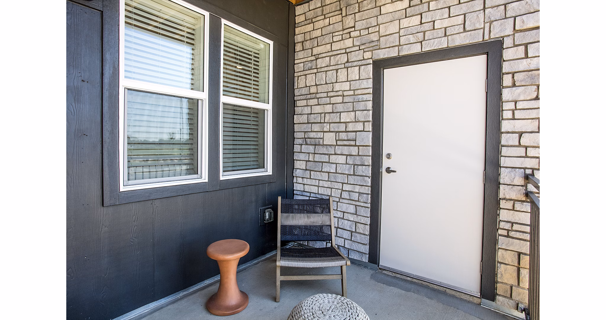 Ascend at Prairie Village: Modern patio space with comfortable seating and lush greenery at luxury apartments in a tranquil setting