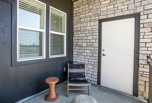 Ascend at Prairie Village: Modern patio space with comfortable seating and lush greenery at luxury apartments in a tranquil setting
