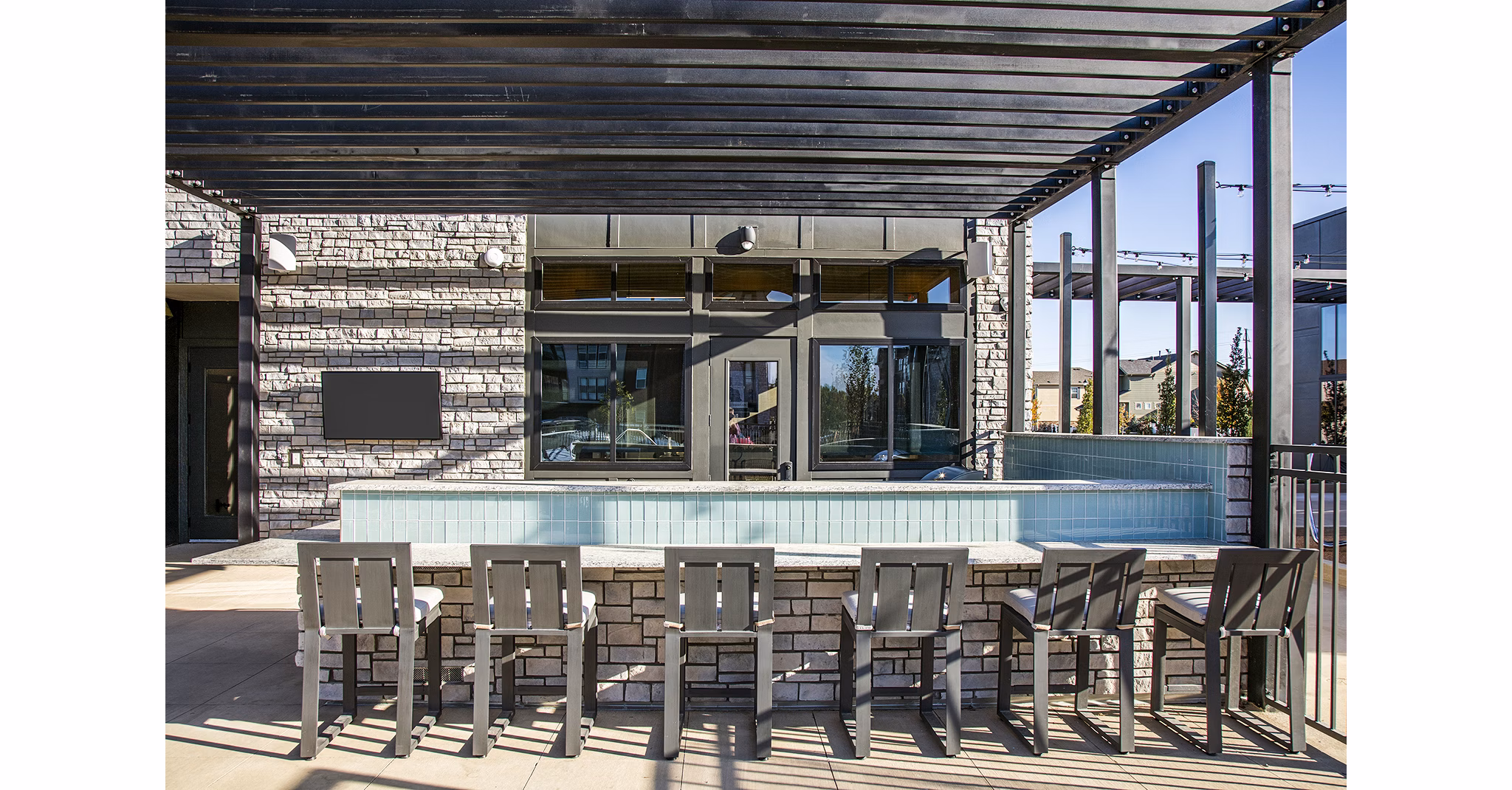 Outdoor grill area with modern seating at Ascend at Prairie Village Apartments, ideal for social gatherings and BBQs