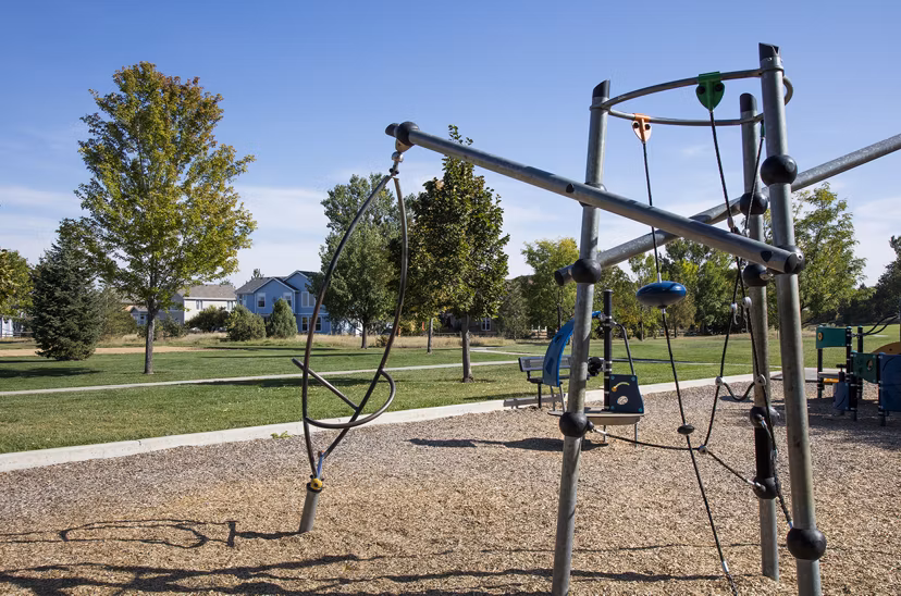Colorful playground at Ascend Prairie Village Apartments offering fun outdoor activities for children and families
