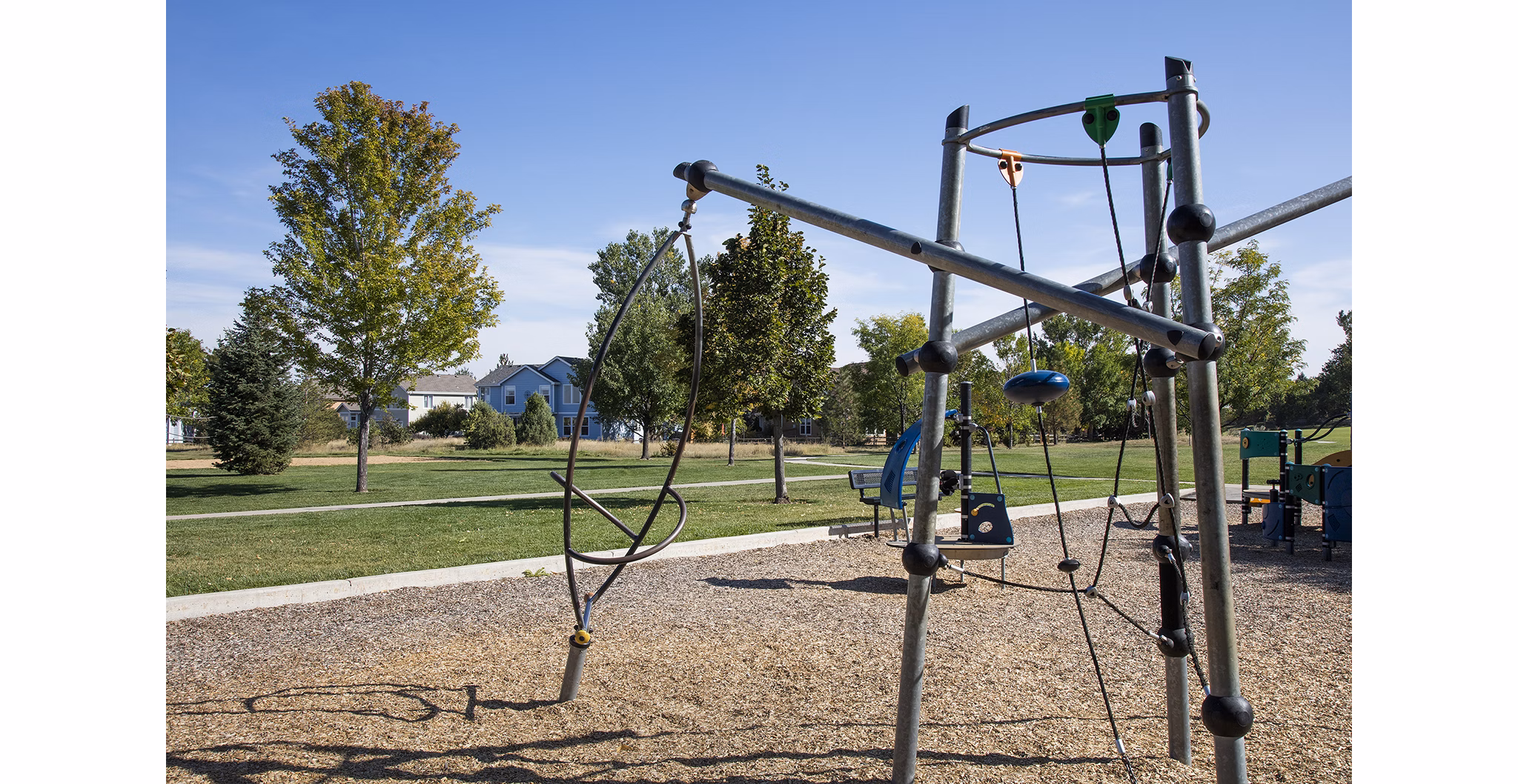 Colorful playground at Ascend Prairie Village Apartments offering fun outdoor activities for children and families