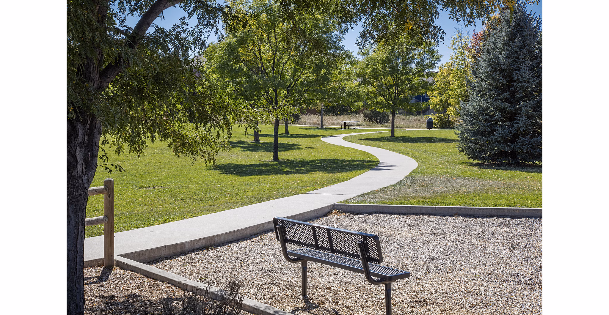 Inviting courtyard with lush greenery and seating at Ascend Prairie Village Apartments, providing a serene outdoor space for residents