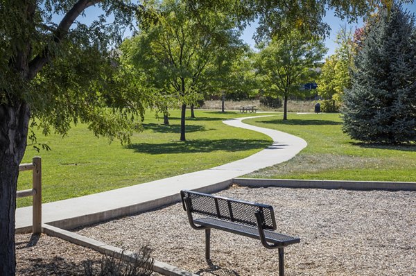 Inviting courtyard with lush greenery and seating at Ascend Prairie Village Apartments, providing a serene outdoor space for residents
