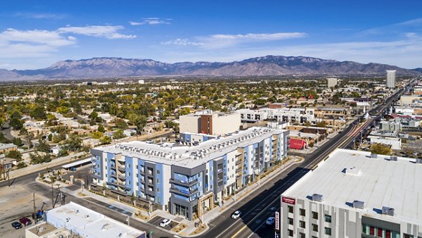 Cityscape aerial view featuring modern luxury apartments with mountains in the background