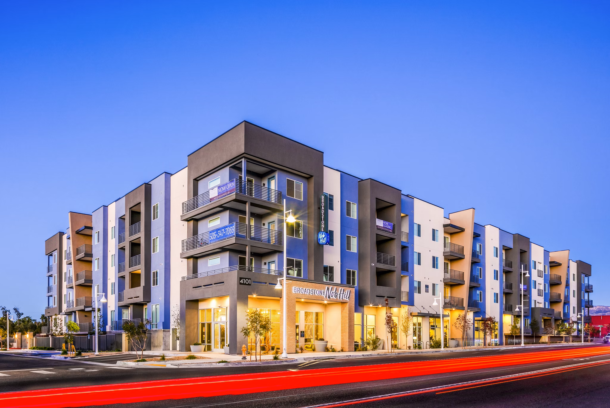 Modern luxury apartment building with balconies and clear blue sky in the background