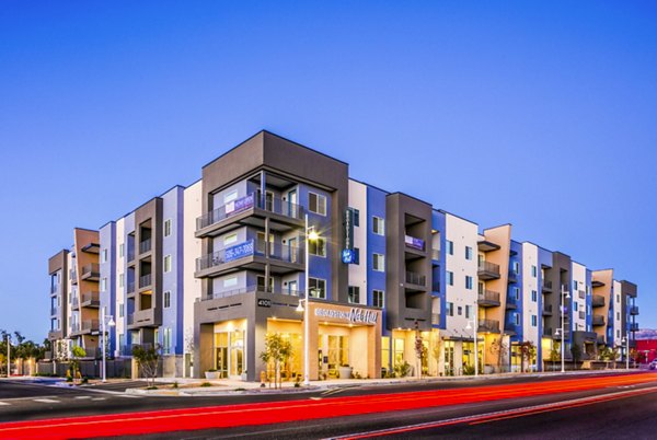 Modern luxury apartment building with balconies and clear blue sky in the background