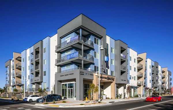 Modern luxury apartment building with multiple floors and balconies in an urban setting