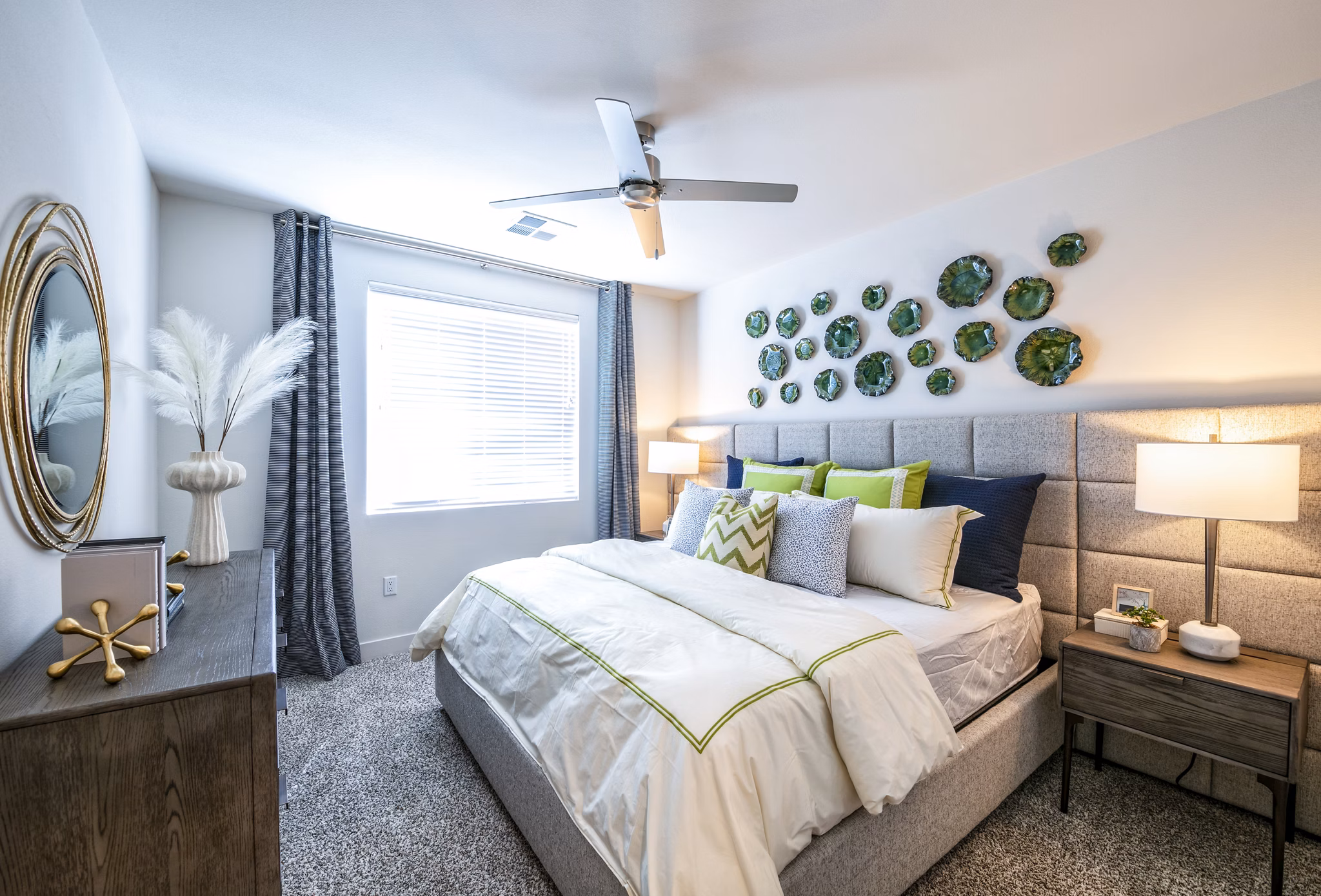 Modern bedroom featuring a cozy bed, stylish nightstands, and decorative wall art in luxury apartments