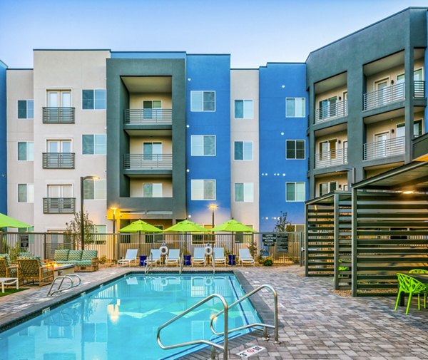 Luxury apartment complex with a refreshing swimming pool in the foreground