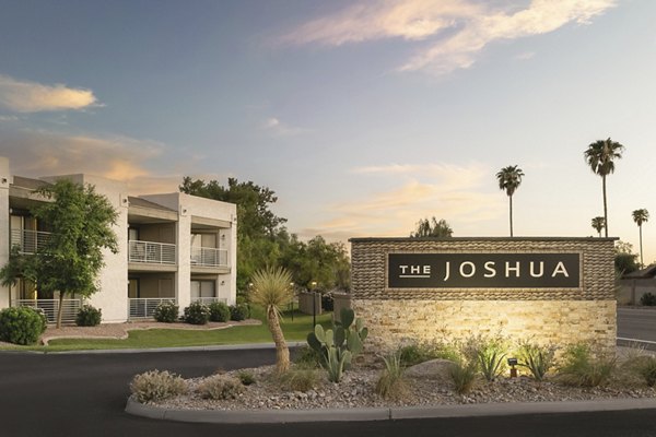 The Joshua: Luxury apartment complex with palm trees and desert landscaping in a serene environment