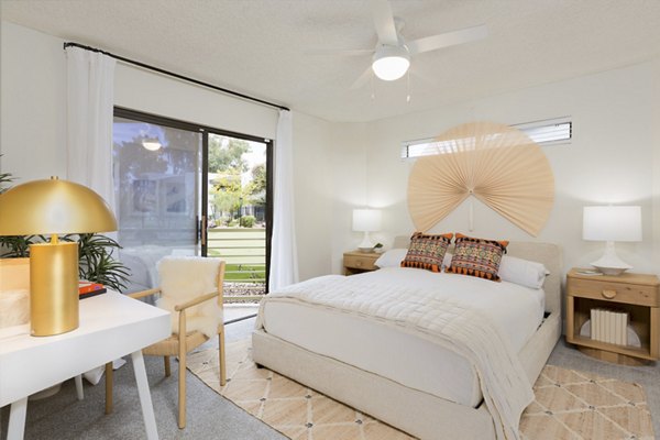 Luxurious bedroom featuring designer furnishings at The Joshua Apartments, offering upscale living in a premium Greystar community