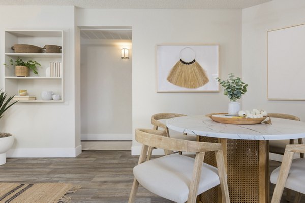 Dining area featuring modern furniture and elegant lighting in The Joshua Apartments