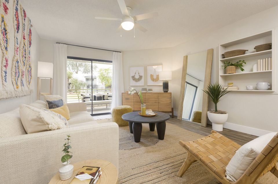 Spacious living room with modern decor and natural light in The Joshua Apartments
