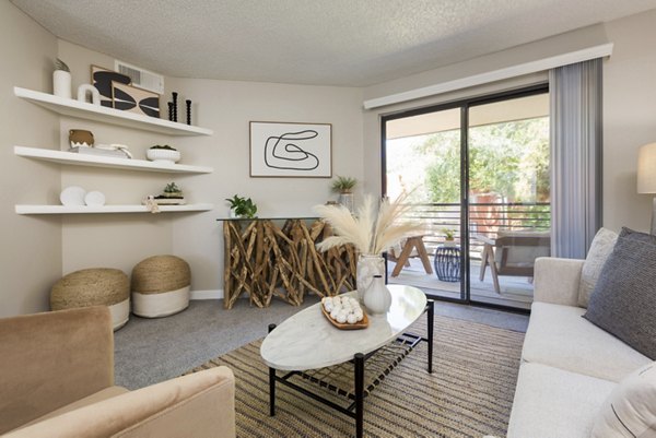 Spacious living room featuring modern decor at The Joshua Apartments in Greystar community