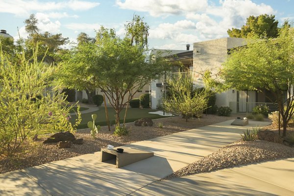 Spacious courtyard with lush greenery at The Joshua Apartments, perfect for relaxation and community gatherings