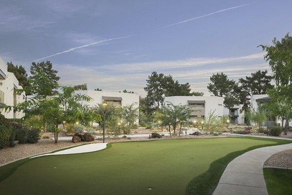 Putting green at The Joshua Apartments, a luxury amenity for relaxation and recreation in a serene community setting