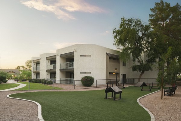The Joshua Apartments: Dog park with agility equipment and shaded seating