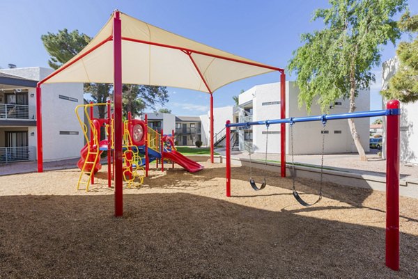 Modern playground with colorful equipment at The Joshua Apartments, offering a family-friendly outdoor space for residents