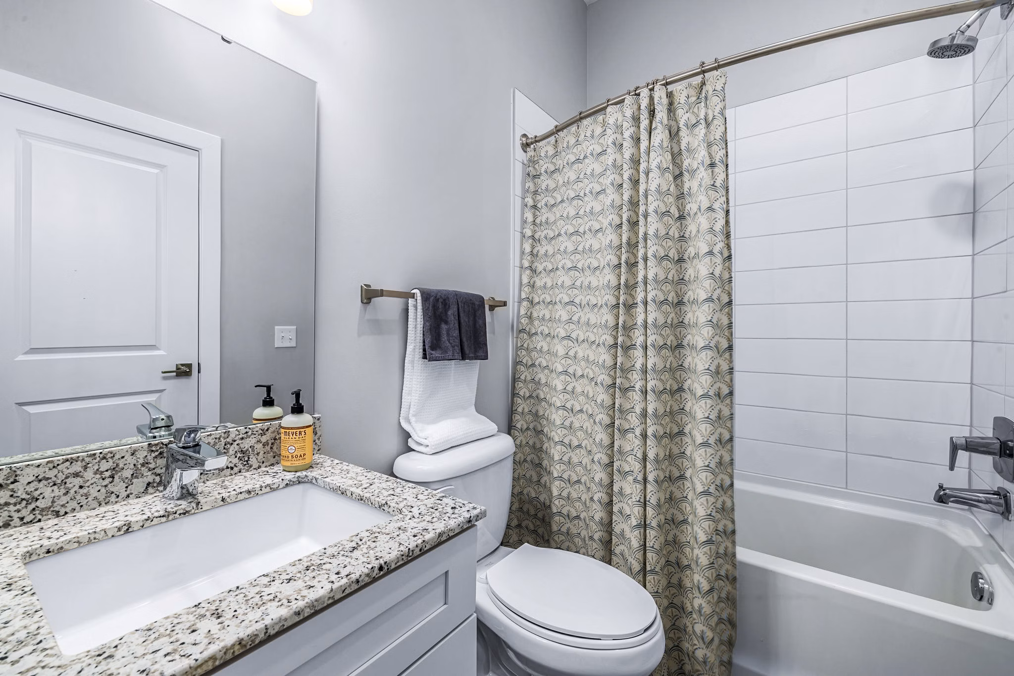 Modern bathroom featuring sleek fixtures and granite countertops at Griffin Weston Apartments