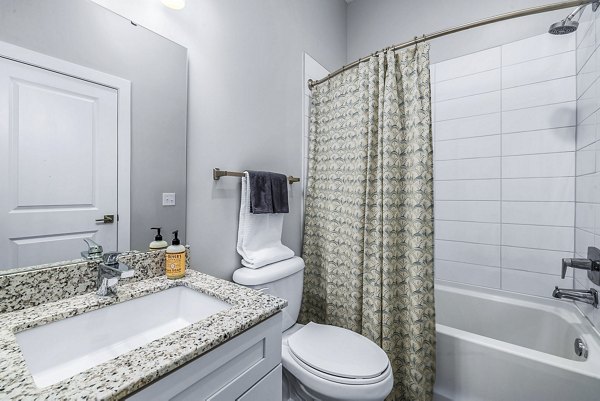 Modern bathroom featuring sleek fixtures and granite countertops at Griffin Weston Apartments
