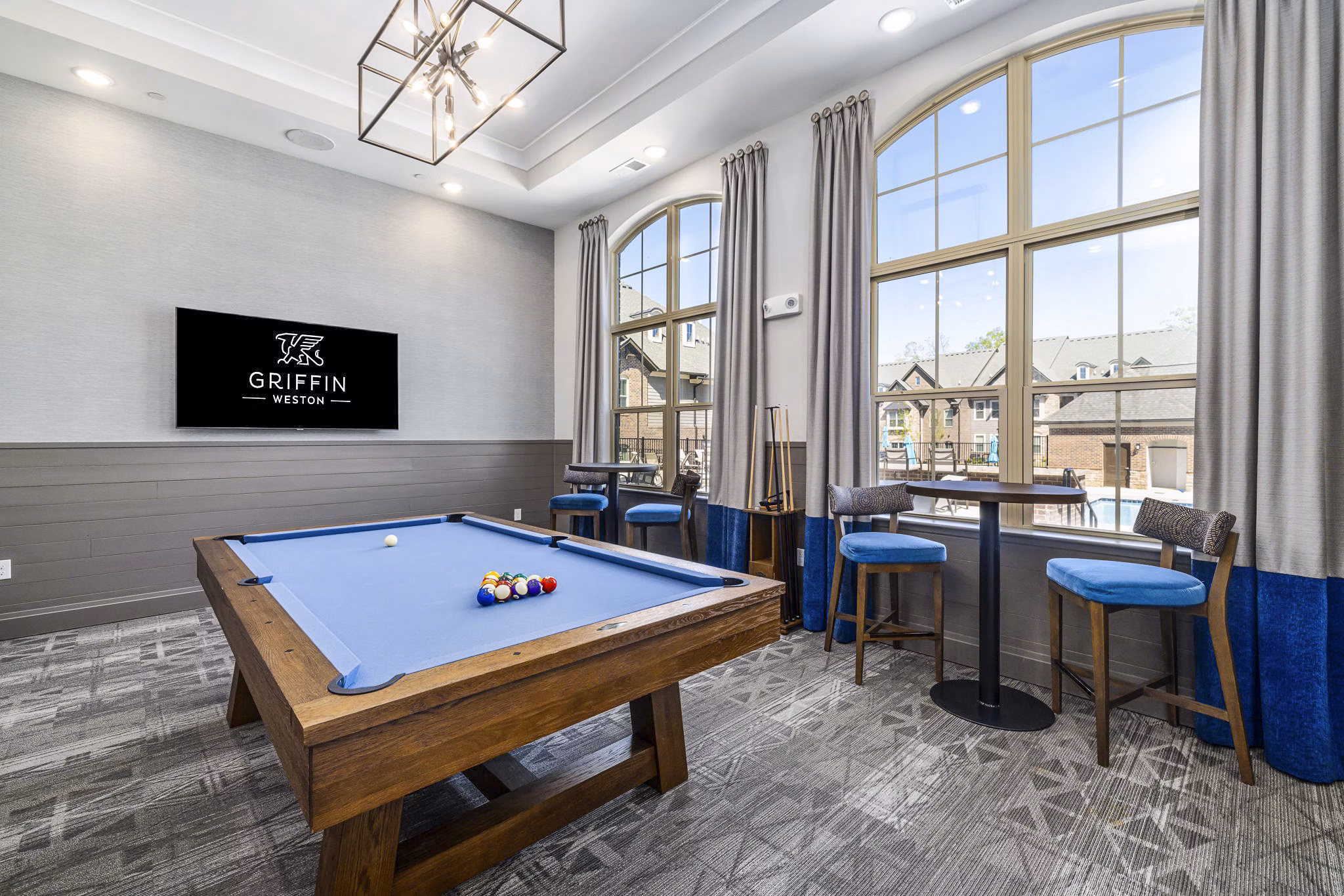 Clubhouse game room with pool table and lounge seating at Griffin Weston Apartments, luxury living experience