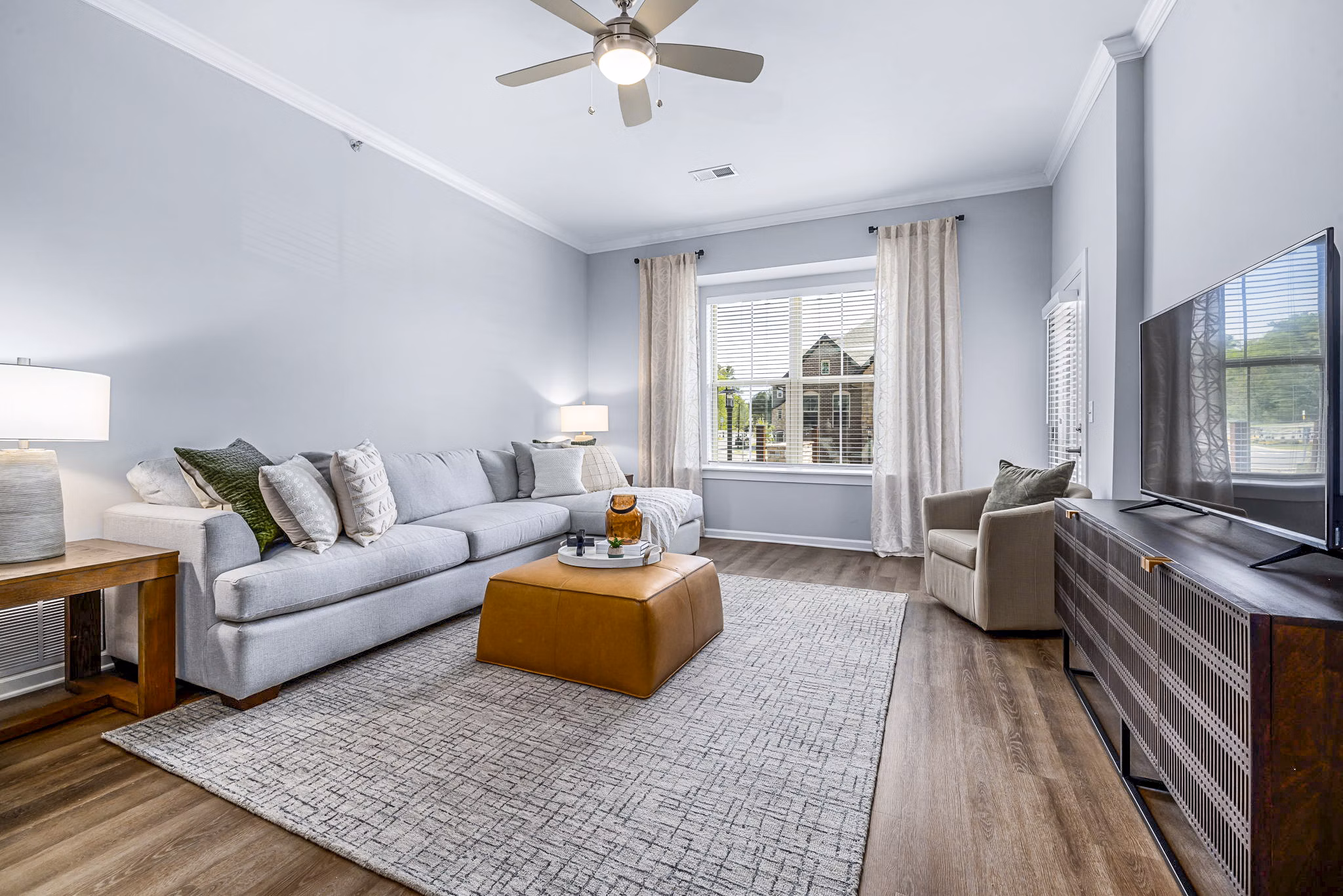 Modern living room with plush seating and natural light at Griffin Weston Apartments, a luxury Greystar property