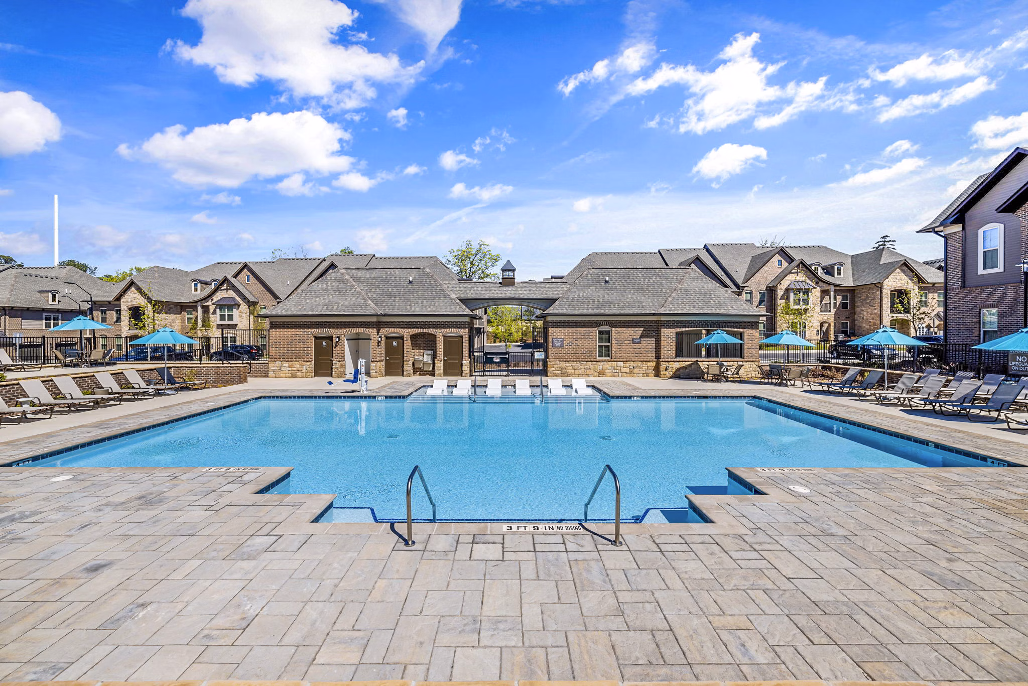 Inviting outdoor pool at Griffin Weston Apartments featuring sun loungers and lush landscaping, perfect for leisure and relaxation