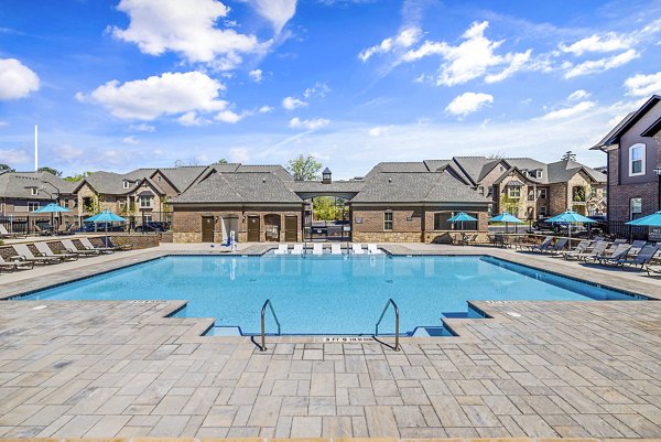 Inviting outdoor pool at Griffin Weston Apartments featuring sun loungers and lush landscaping, perfect for leisure and relaxation