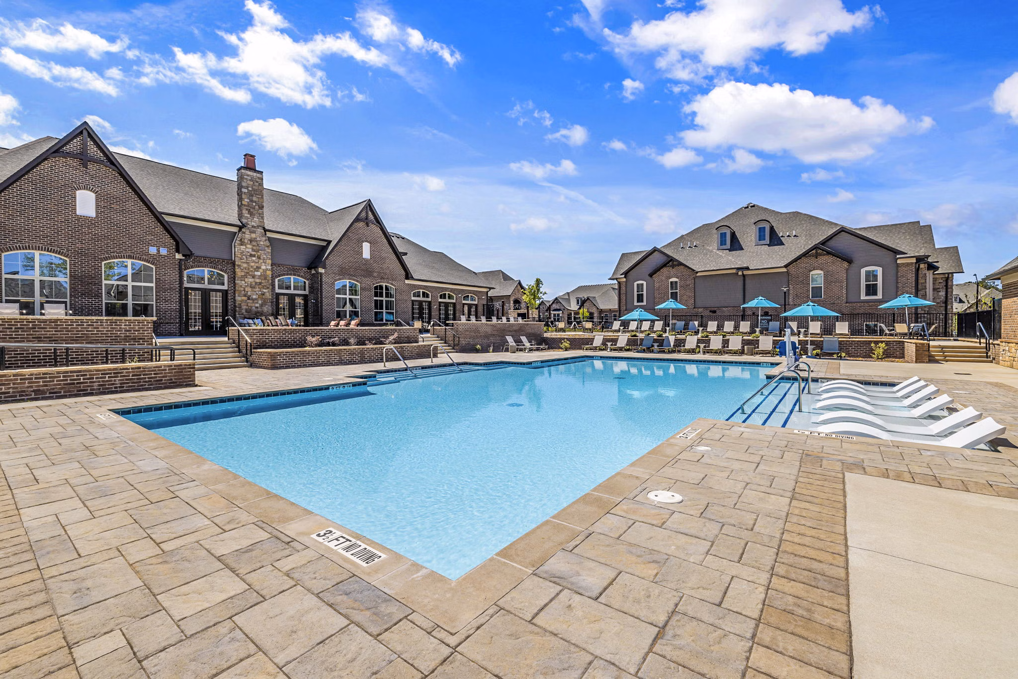 Luxurious pool at Griffin Weston Apartments with lounge chairs and scenic views, perfect for relaxation at Greystar's premier property