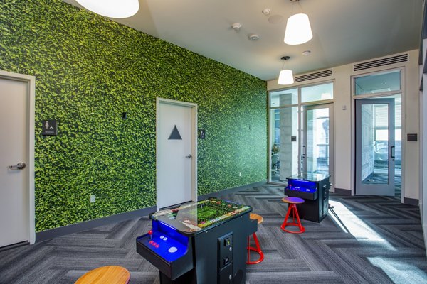 Game room with billiards table and seating area at Oceanaire Apartments, perfect for socializing and entertainment in a luxury setting