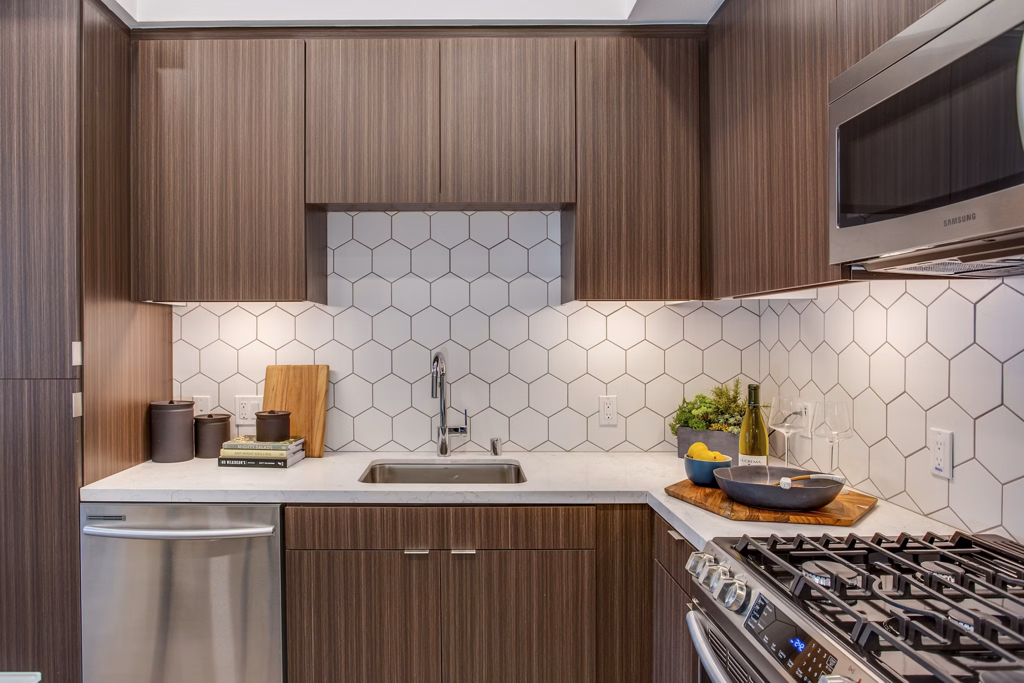 Modern kitchen with stainless steel appliances at Oceanaire Luxury Apartments