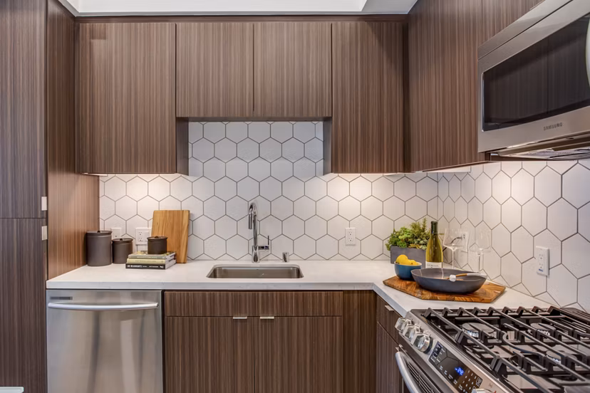 Modern kitchen with stainless steel appliances at Oceanaire Luxury Apartments