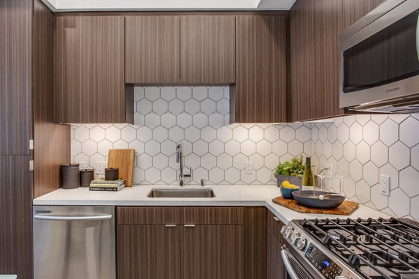 Modern kitchen with stainless steel appliances at Oceanaire Luxury Apartments