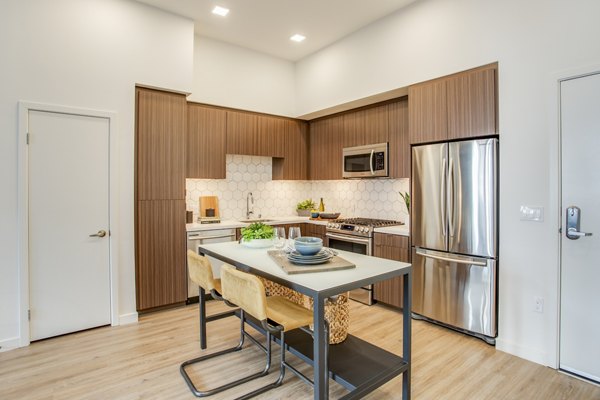 Contemporary kitchen with stainless steel appliances at Oceanaire Apartments