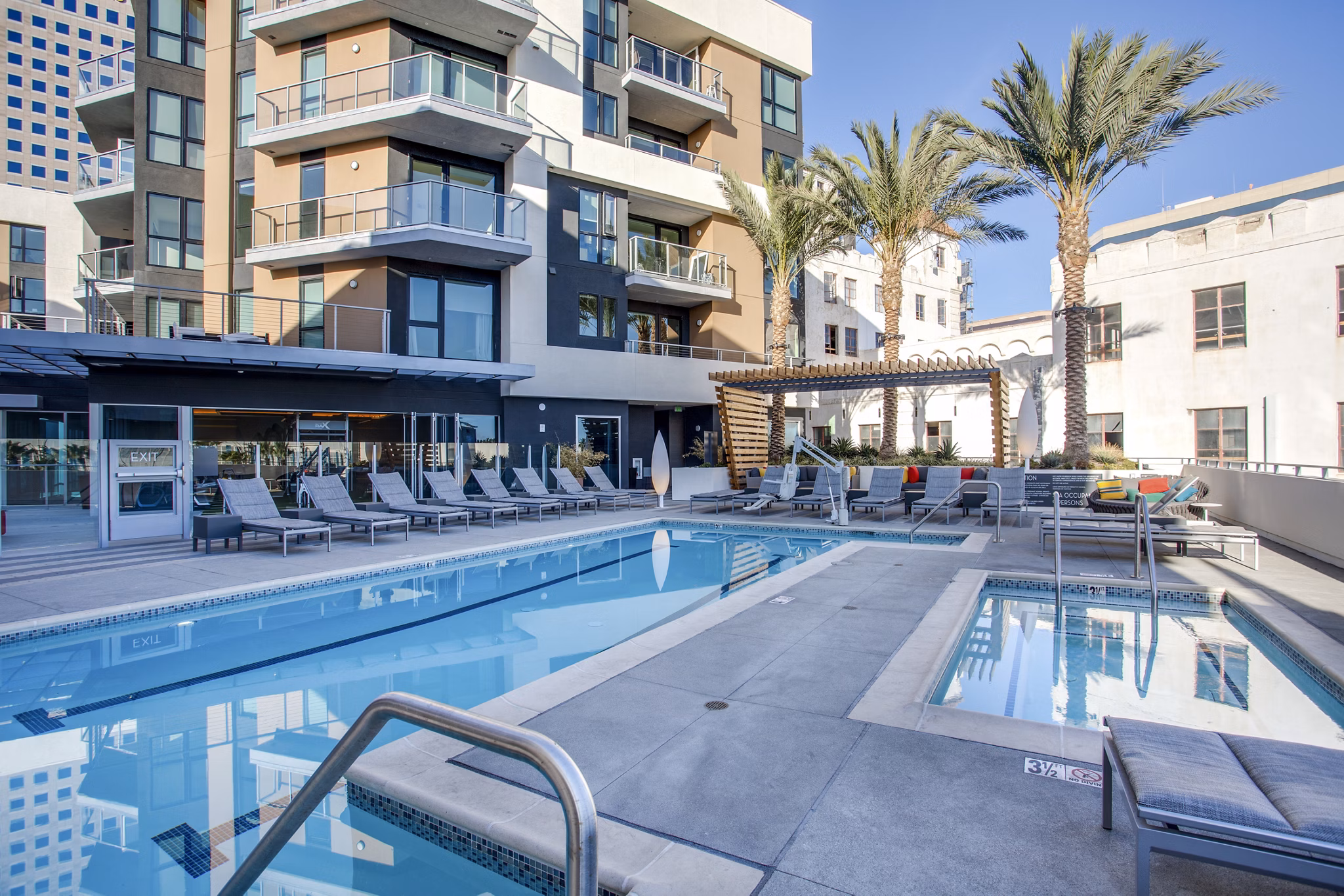Resort-style pool area with lush landscaping at Oceanaire Apartments, offering luxury living near the beach