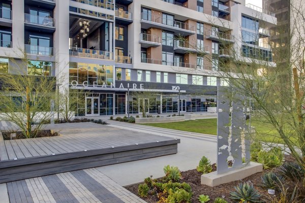 Oceanaire Apartments: Serene courtyard with lush landscaping in Greystar's luxury waterfront living community