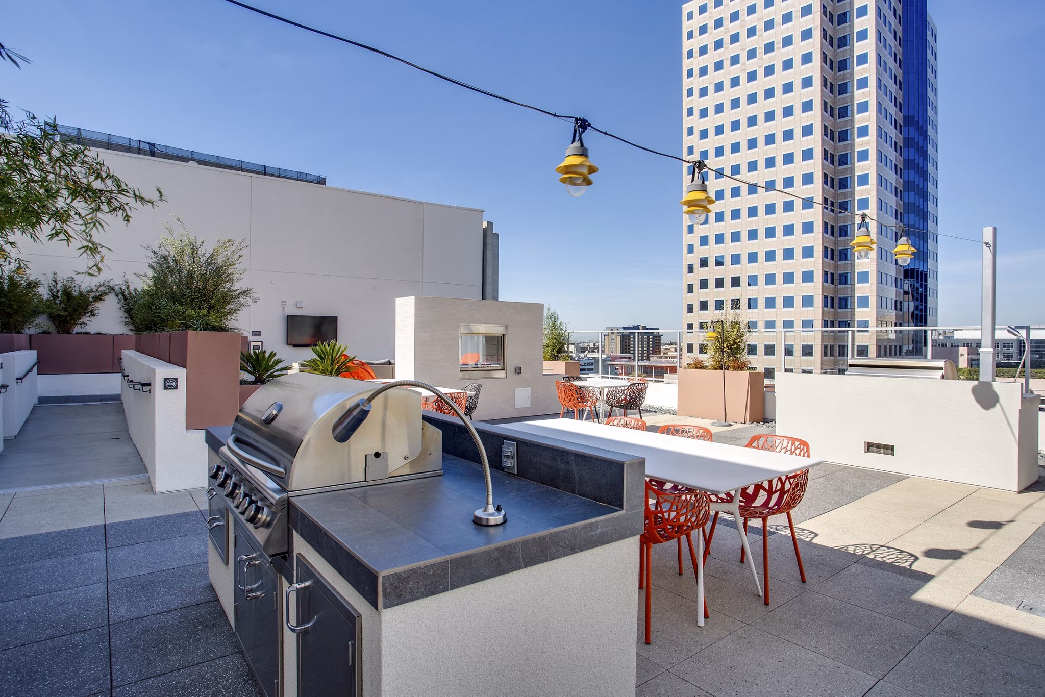 Modern outdoor grill area with seating at Oceanaire Apartments, offering luxury apartment living experience by Greystar