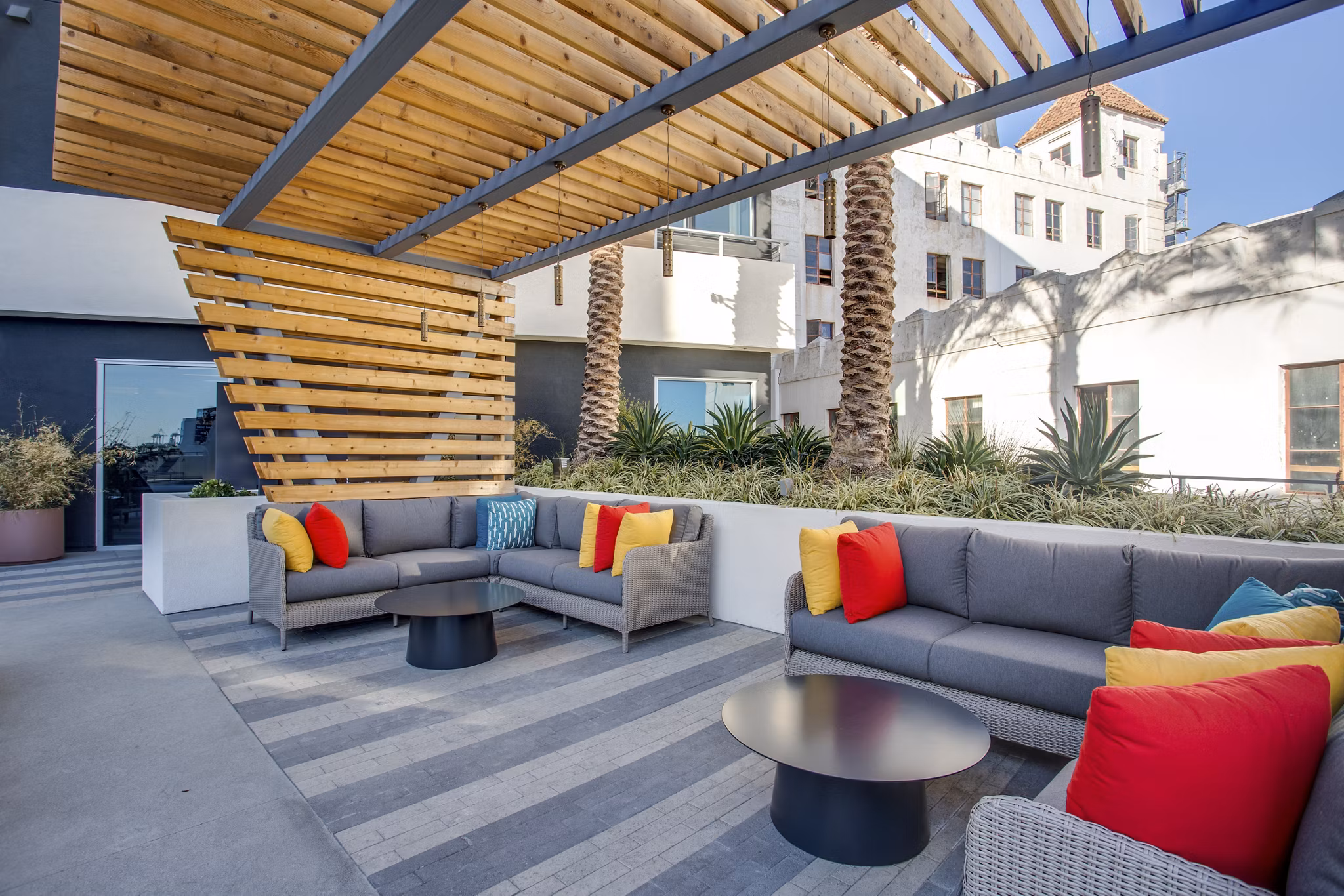 Patio lounge with modern seating and ocean views at Oceanaire Apartments, a Greystar luxury property in a coastal setting